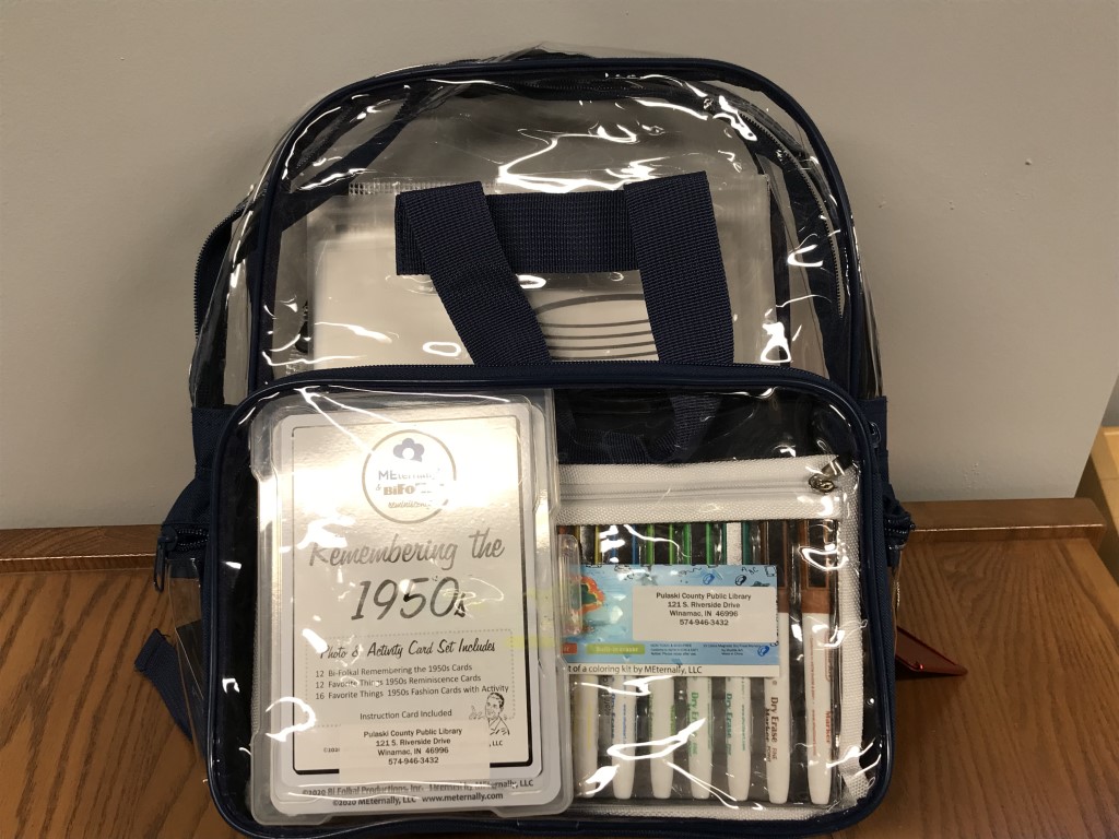 backpack filled with items for "Favorite Things: Remembering the 1950s"