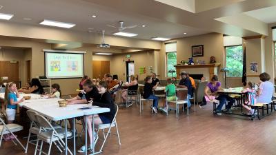 A large group of people at the End of Summer Reading party in the library's Reading Room.