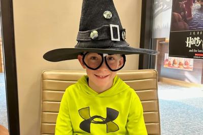 Boy wearing Harry Potter glasses and Sorting Hat