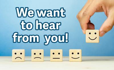 a row of block with painted smiley faces, running from sad to neutral to happy