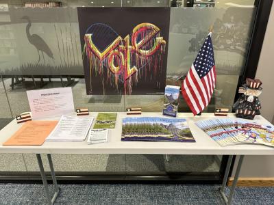 A table displaying a variety of flyers and handouts with information about upcoming elections in 2024.