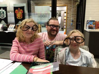 an man with two girls wearing glasses made of pipe cleaners for Harry Potter Book Day