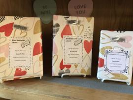 Books covered with Valentine's Day wrapping paper on display for Blind Date with a Book.